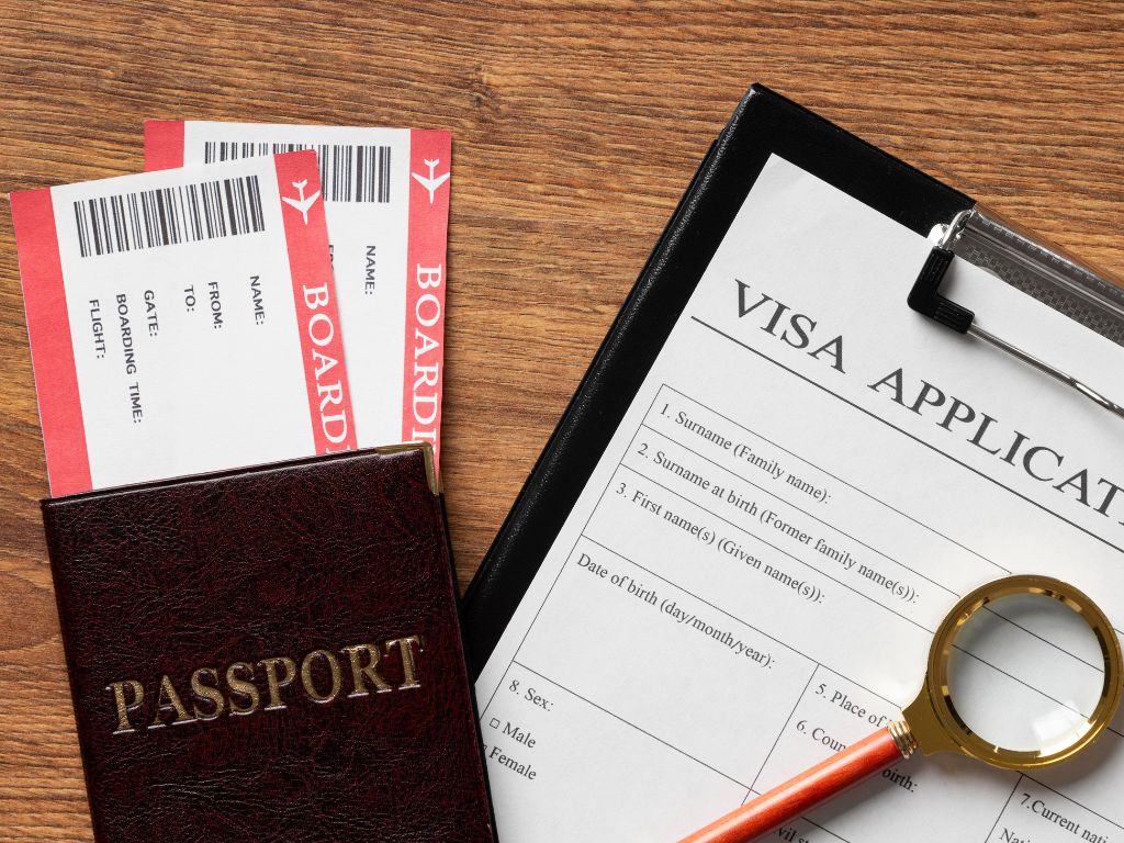 documents required for visa application along with passport and a magnifying glass